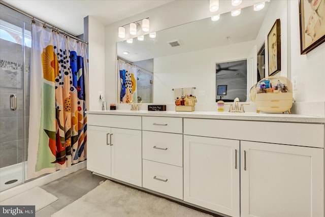 bathroom with double vanity, visible vents, a shower stall, and a sink