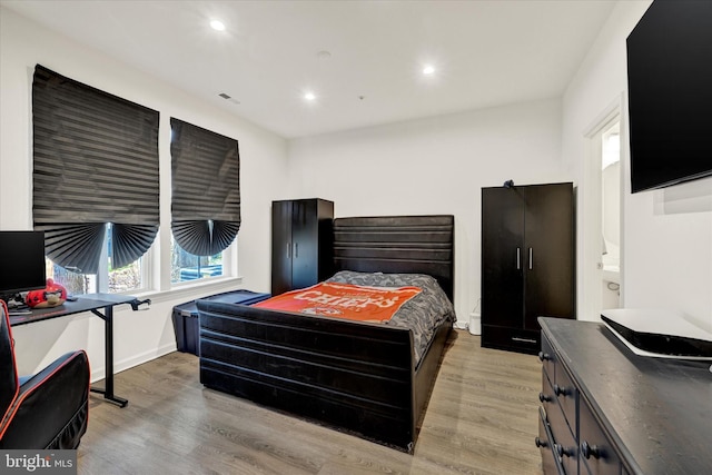 bedroom with recessed lighting, wood finished floors, and visible vents