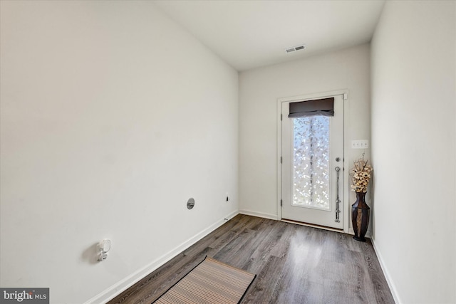 spare room featuring visible vents, baseboards, and wood finished floors