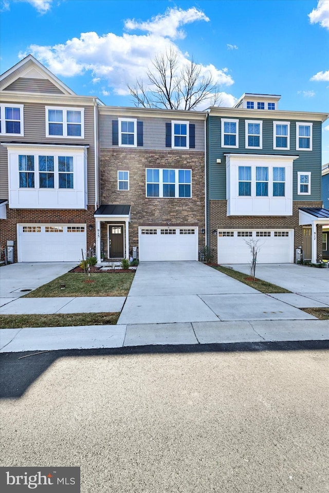 view of front of house featuring an attached garage, brick siding, and driveway