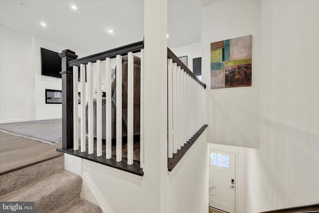 stairs featuring recessed lighting and baseboards