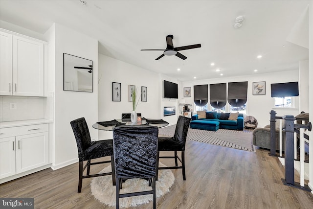 dining room featuring recessed lighting, wood finished floors, baseboards, and ceiling fan