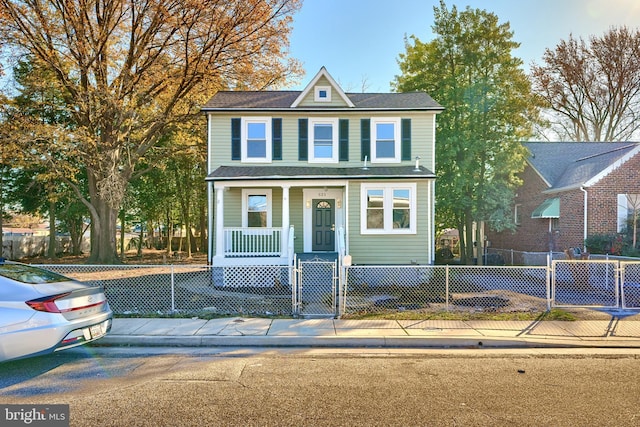 view of front of house with a fenced front yard, a porch, and a gate