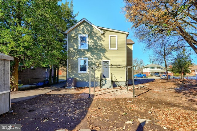 rear view of house featuring entry steps