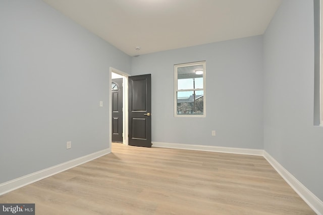 unfurnished bedroom with baseboards and light wood-style floors