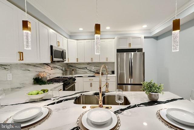 kitchen featuring light countertops, tasteful backsplash, appliances with stainless steel finishes, and ornamental molding