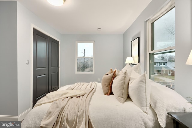 bedroom featuring visible vents, baseboards, and a closet