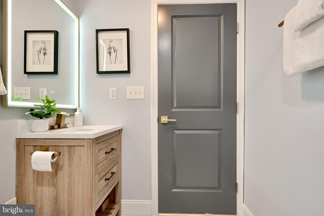 bathroom featuring baseboards and vanity