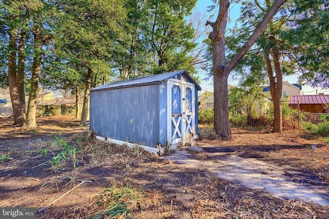 view of shed featuring fence