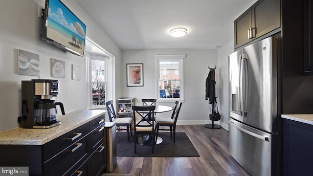 dining room with baseboards and dark wood-style flooring