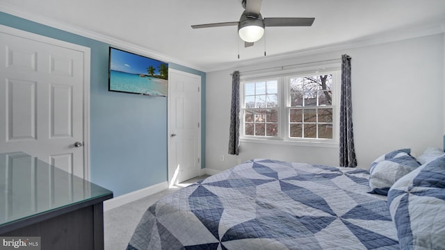 bedroom featuring baseboards, a ceiling fan, crown molding, and carpet
