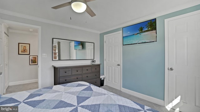 carpeted bedroom featuring baseboards, crown molding, and ceiling fan