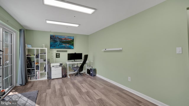 office space with baseboards and wood finished floors