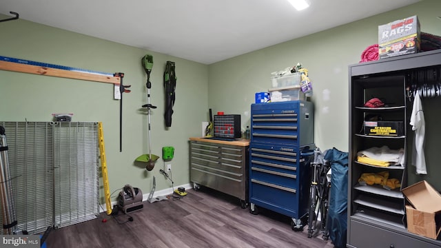 miscellaneous room featuring baseboards and dark wood-style flooring