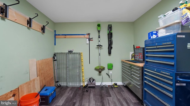 interior space featuring baseboards and dark wood finished floors