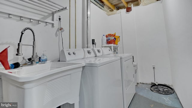 clothes washing area featuring separate washer and dryer
