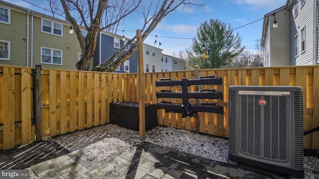 view of patio / terrace featuring central air condition unit and fence