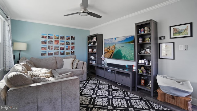 living area with wood finished floors, ornamental molding, and a ceiling fan