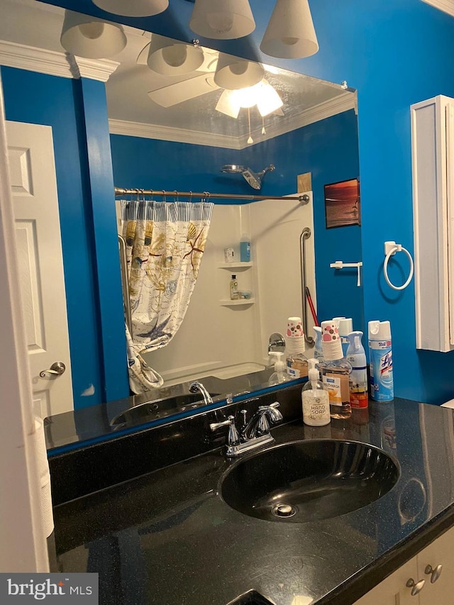 full bath featuring curtained shower, ornamental molding, and vanity