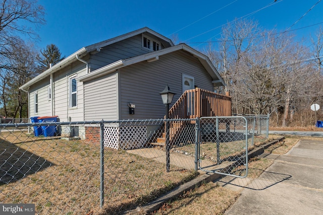 view of property exterior with a gate and fence