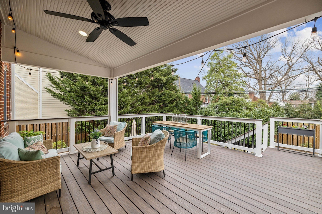 wooden terrace featuring an outdoor living space, outdoor dining area, and ceiling fan