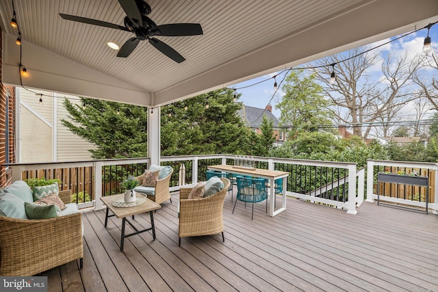 wooden terrace featuring an outdoor living space, outdoor dining area, and ceiling fan