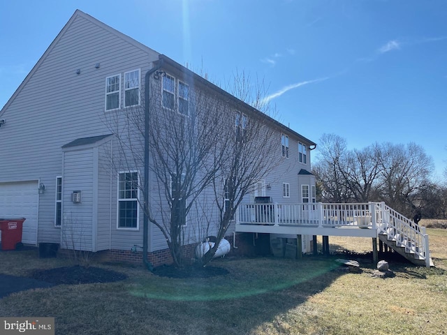 view of home's exterior featuring stairs, a yard, and a wooden deck