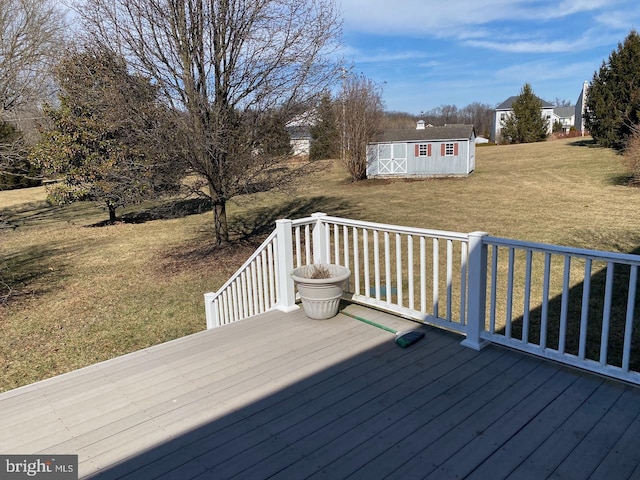 wooden deck featuring a yard, an outdoor structure, and a shed