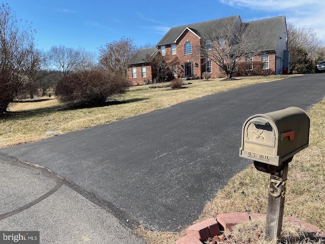 view of front of property featuring a front lawn and brick siding