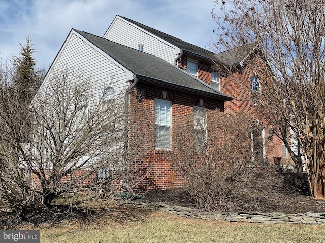 view of property exterior with brick siding