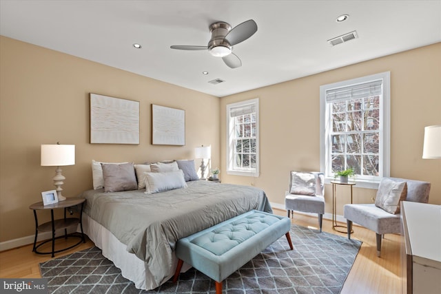 bedroom with recessed lighting, visible vents, baseboards, and dark wood-style floors