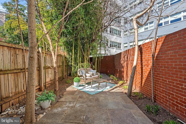 view of patio with an outdoor living space and a fenced backyard