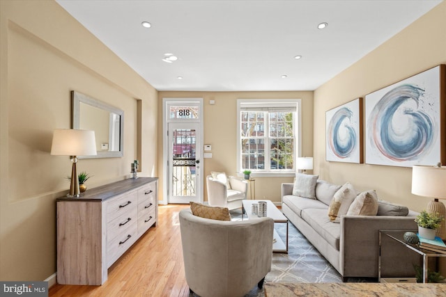 living room featuring recessed lighting, light wood-type flooring, and baseboards