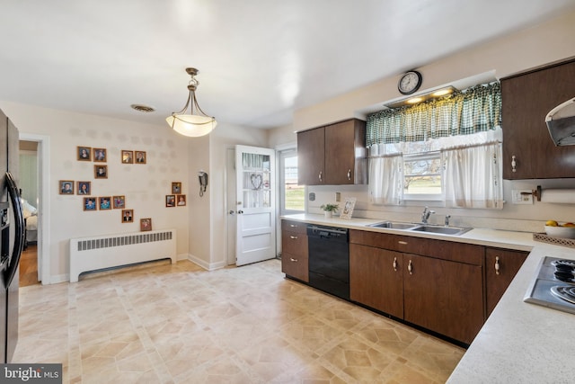 kitchen featuring radiator, black appliances, light countertops, and a sink