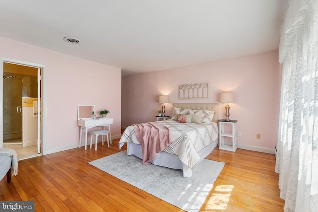 bedroom featuring visible vents, baseboards, and light wood-style floors