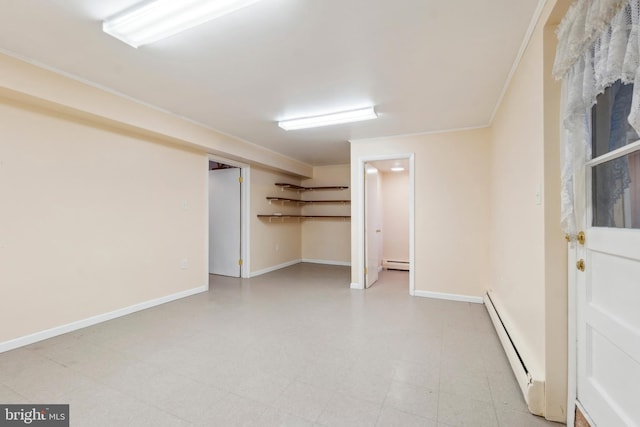 finished basement featuring a baseboard heating unit, baseboards, light floors, and ornamental molding