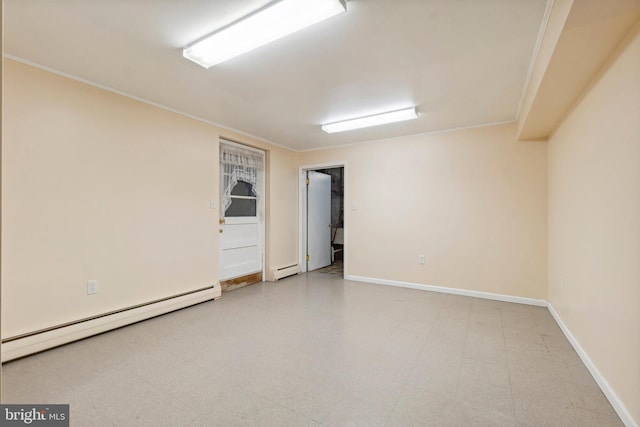 spare room featuring a baseboard heating unit, light floors, baseboards, and ornamental molding