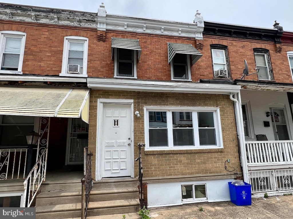 multi unit property featuring cooling unit and brick siding