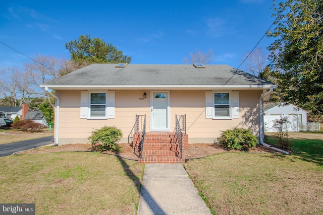 bungalow-style home with a front yard and a shingled roof