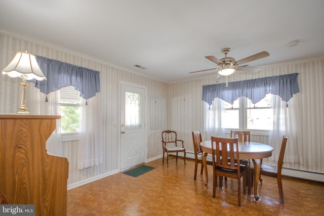 dining room with baseboards, visible vents, wallpapered walls, ceiling fan, and crown molding