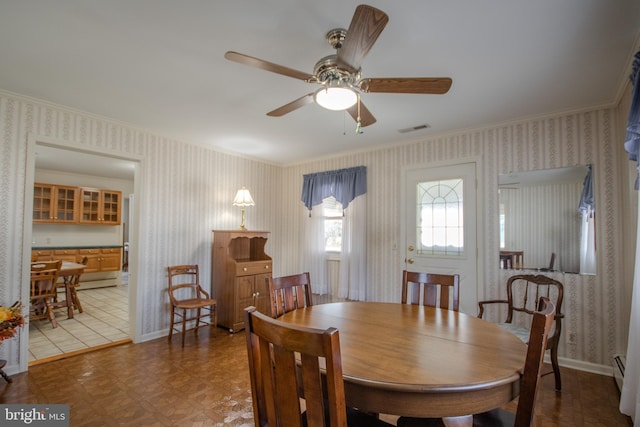 dining space with visible vents, baseboards, ceiling fan, and wallpapered walls