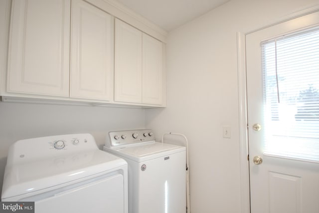 clothes washing area with cabinet space and washer and clothes dryer