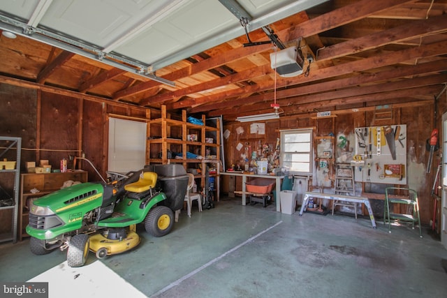 garage with a workshop area and a garage door opener