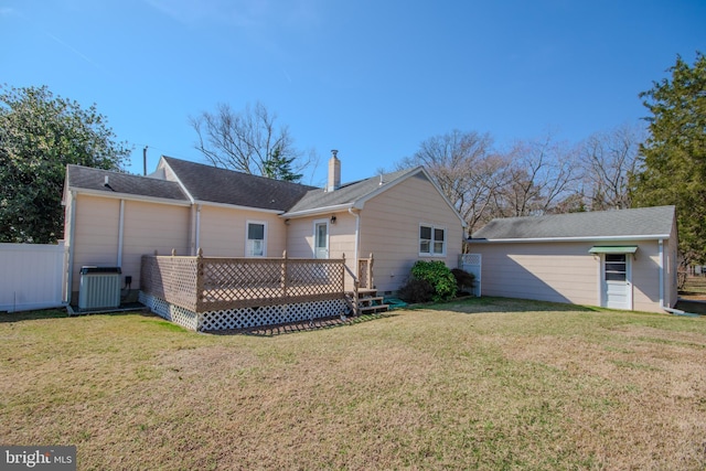 back of house featuring a yard, central AC unit, a deck, and fence