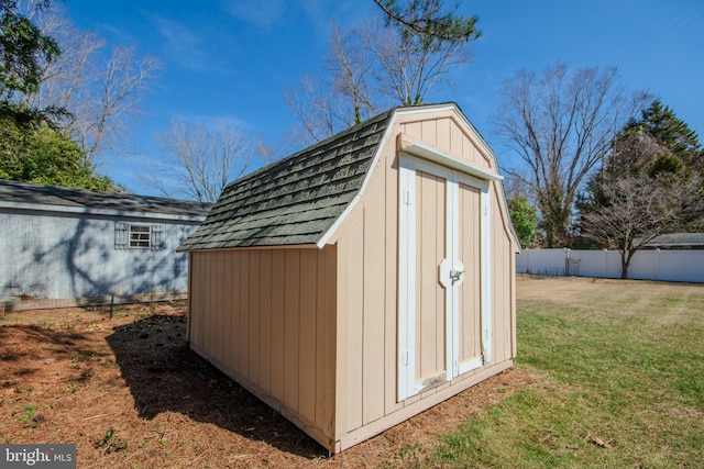 view of shed featuring fence