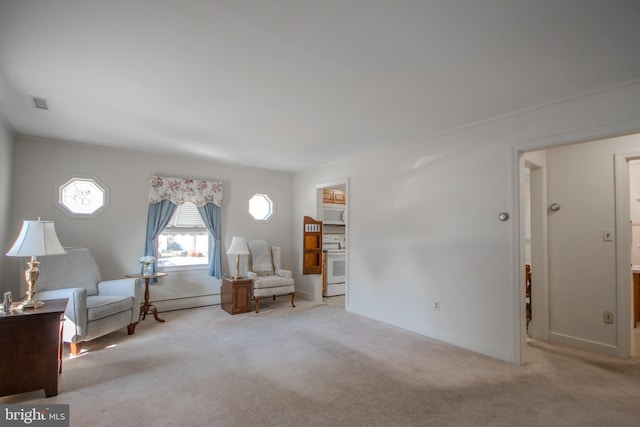 unfurnished room featuring visible vents, carpet floors, baseboards, and a baseboard radiator