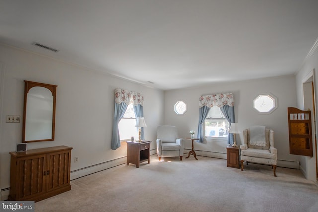 sitting room with visible vents, a healthy amount of sunlight, baseboard heating, and carpet