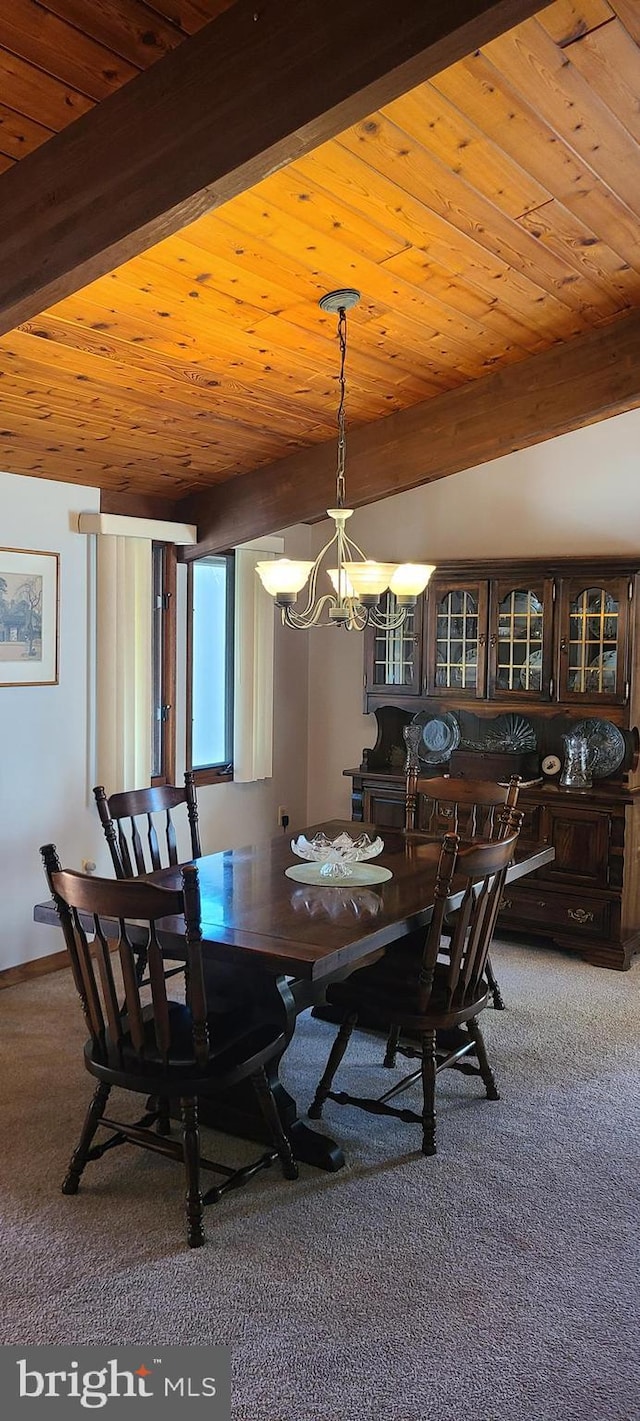 carpeted dining room featuring an inviting chandelier, beam ceiling, wood ceiling, and baseboards