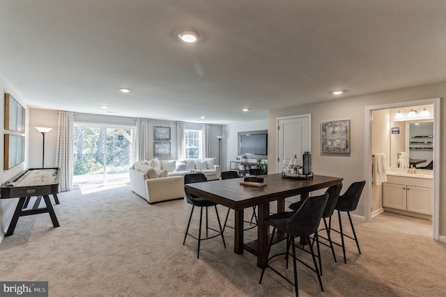 dining room featuring recessed lighting, light colored carpet, and baseboards