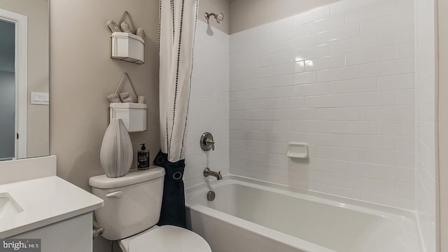 bathroom with vanity, shower / bath combination with curtain, and toilet